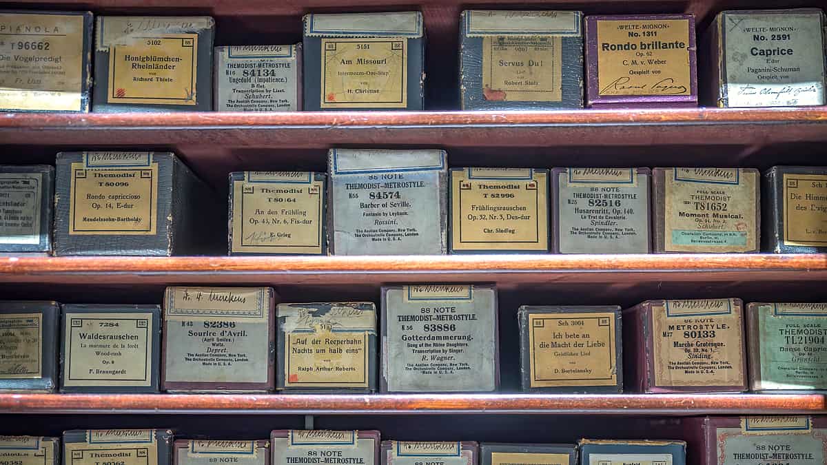 A hardware store aisle lined with small metal drawers, each drawer front carrying a faded handwritten label.